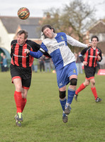 Stuart 'Psycho' Pearce for Longford AFC head to head with Wotton Rovers player with long hair wearing black headband, ball in air