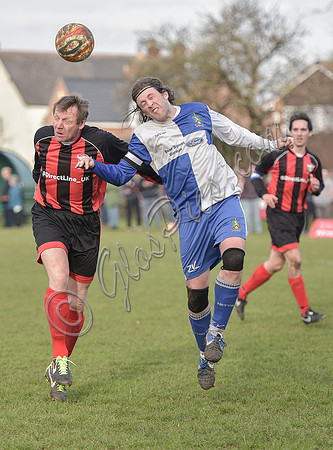Stuart 'Psycho' Pearce for Longford AFC head to head with Wotton Rovers player with long hair wearing black headband, ball in air