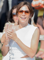 Actress Anna Friel wearing white one shoulder dress, sunglasses