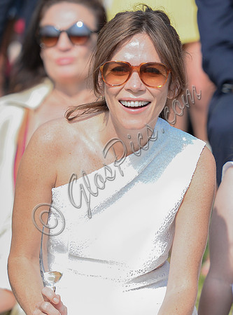 Actress Anna Friel wearing white one shoulder dress, sunglasses