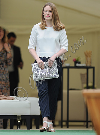 Cara Theobold wearing white top and blue trousers