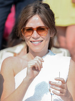 Actress Anna Friel wearing white one shoulder dress, sunglasses