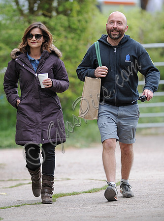 Jenna Coleman on 29th birthday, on set to film Doctor Who, wearing sunglasses and padded purple coat holding polystyrene cup