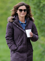 Jenna Coleman on 29th birthday, on set to film Doctor Who, wearing sunglasses and padded purple coat holding polystyrene cup