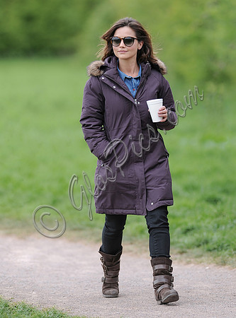 Jenna Coleman on 29th birthday, on set to film Doctor Who, wearing sunglasses and padded purple coat holding polystyrene cup