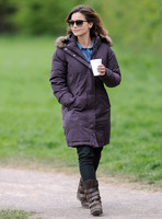 Full length shot of Jenna Coleman on 29th birthday, on set to film Doctor Who, wearing sunglasses and padded purple coat holding polystyrene cup