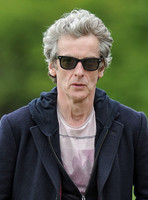 Head shot of Peter Capaldi wearing Ray Ban sunglasses