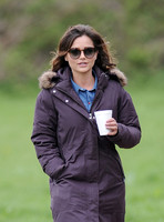 Waist up shot of Jenna Coleman on 29th birthday, on set to film Doctor Who, wearing sunglasses and padded purple coat holding polystyrene cup
