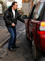 Nicolas Cage wearing jeans and leather flying jacket