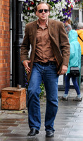 Nicolas Cage wandering around Glastonbury in the rain