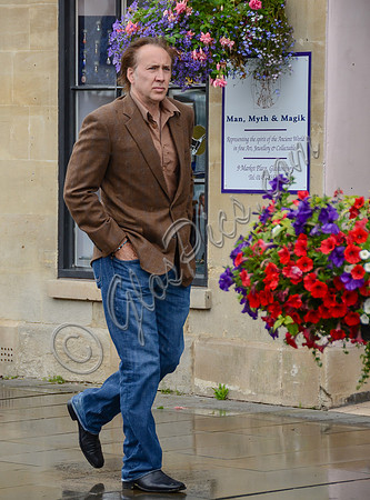 Nicolas Cage wandering past "Man, Myth and Magik" in Glastonbury