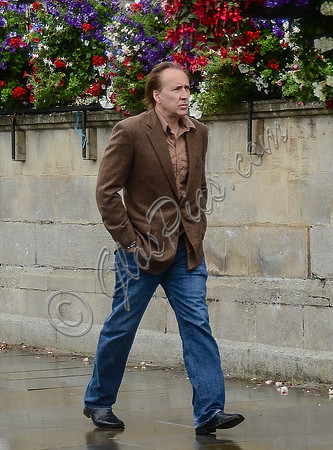 Nicolas Cage wandering around Glastonbury in the rain