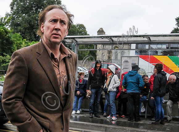 Nicolas Cage wandering around Glastonbury in the rain