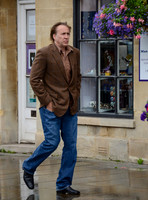 Nicolas Cage wandering past "Man, Myth and Magik" in Glastonbury