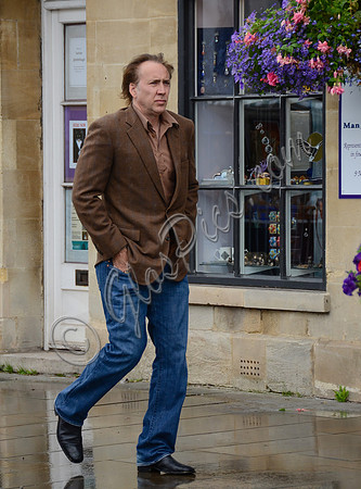 Nicolas Cage wandering past "Man, Myth and Magik" in Glastonbury