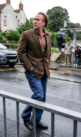 Nicolas Cage wandering around Glastonbury in the rain