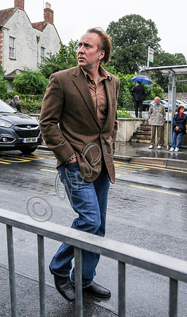 Nicolas Cage wandering around Glastonbury in the rain