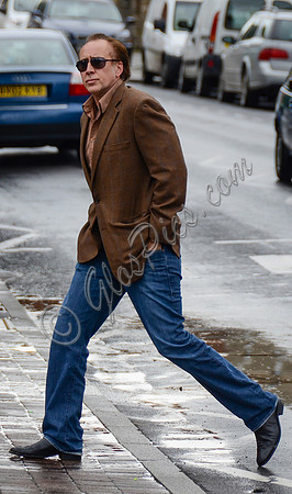 Nicolas Cage wandering around Glastonbury in the rain