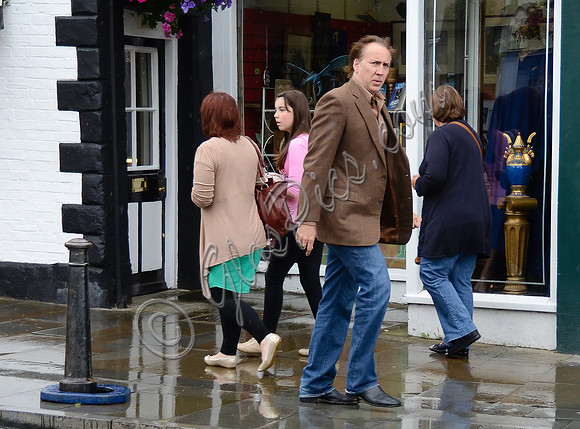 Nicolas Cage wandering around Glastonbury in the rain