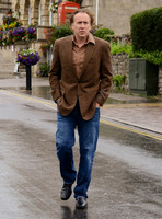 Nicolas Cage wandering around Glastonbury in the rain