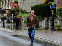 Nicolas Cage wandering around Glastonbury in the rain
