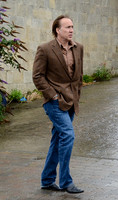 Nicolas Cage wandering around Glastonbury in the rain