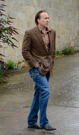 Nicolas Cage wandering around Glastonbury in the rain