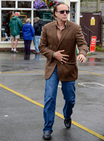 Nicolas Cage wandering around Glastonbury in the rain