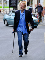 Blonde and bearded, Nicolas Cage with silver tipped walking cane