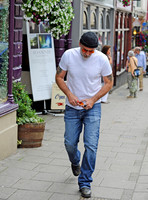 Nicolas Cage wearing beanie hat and orange glasses
