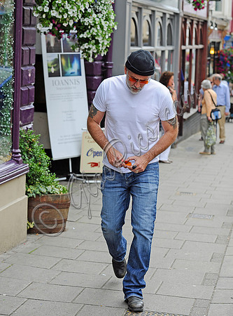 Nicolas Cage wearing beanie hat and orange glasses