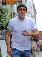 Nicolas Cage wearing beanie hat and orange glasses