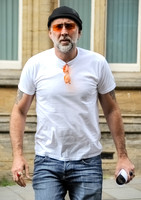 Nicolas Cage wearing beanie hat and orange glasses