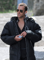 Close up of Matthew Lewis wearing sunglasses and earphones