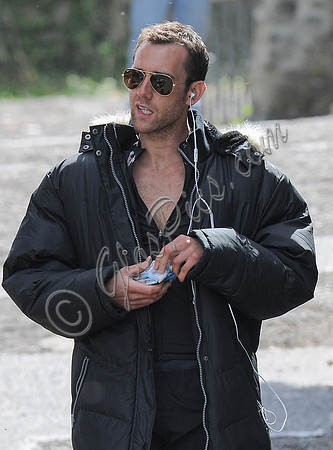Close up of Matthew Lewis wearing sunglasses and earphones