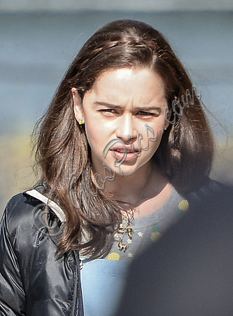 Close up head shot of Emilia Clarke, hair down with plaited band