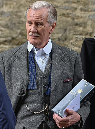 Close up of David Robb with champagne and card