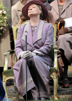 Maggie Smith as Violet Crawley wearing lilac sitting with nose in the air.