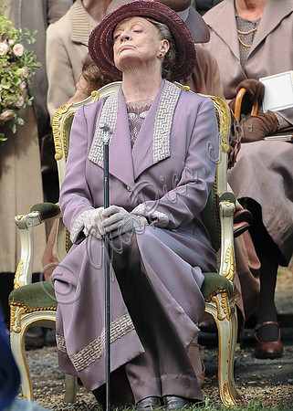 Maggie Smith as Violet Crawley wearing lilac sitting with nose in the air.