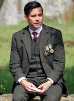 Rob James-Collier sat on cotswold wall