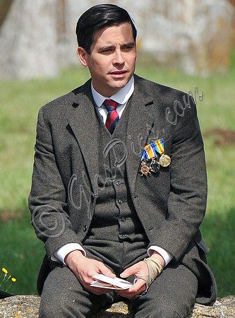 Rob James-Collier sat on cotswold wall