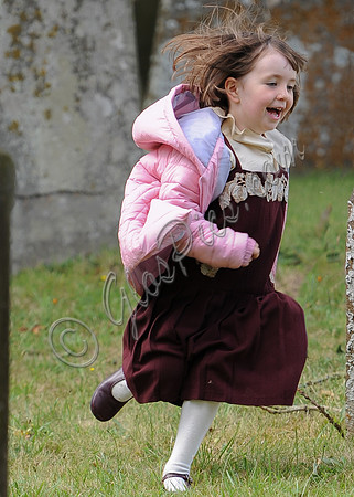 Fifi Hart playing in churchyard