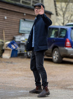 Benedict Cumberbatch wearing denim shirt, flat cap and glasses