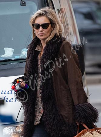 Kate Moss alone wearing sunglasses