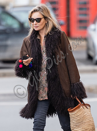 Kate Moss alone wearing sunglasses