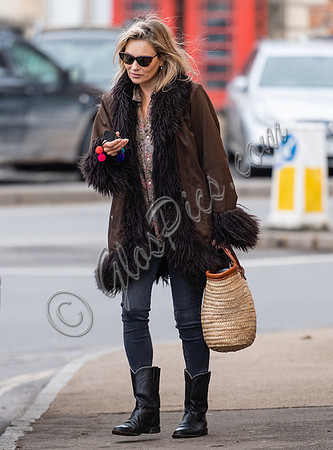 Kate Moss alone wearing sunglasses