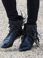 close up view of black leather fringed ankle boot