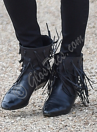 close up view of black leather fringed ankle boot