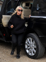 Meg Matthews dressed in black getting out of range Rover