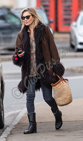 Kate Moss alone wearing sunglasses